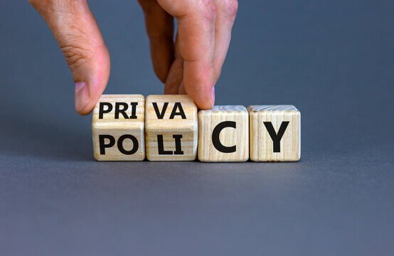 A few wooden blocks sitting one by the other and displaying privacy policy